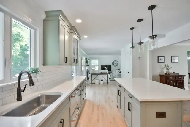 Castleton, NY kitchen remodel with light teal cabinets, white quartz counters and glass pendant lights
